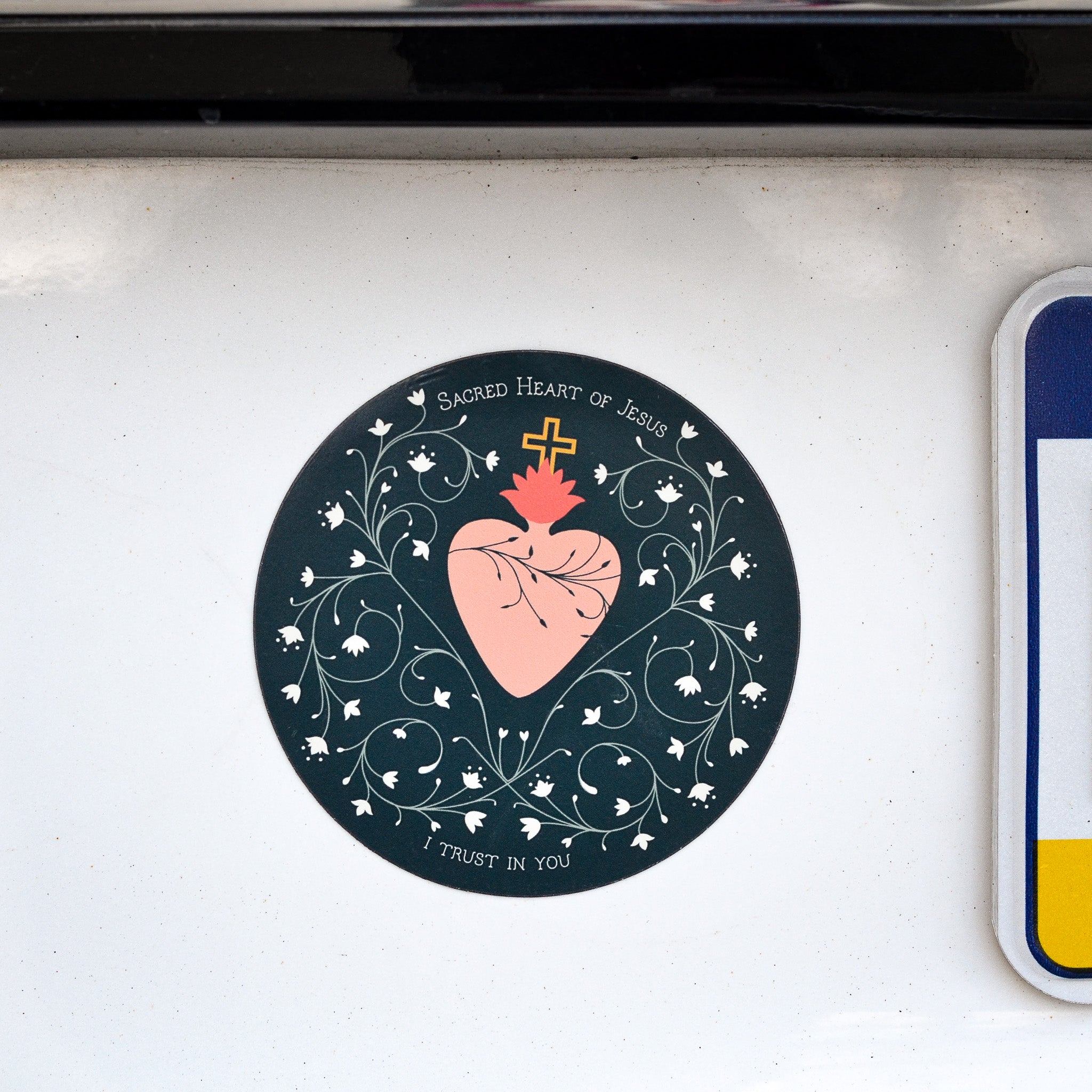 sacred heart magnet on car by license plate